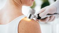 A doctor conducting a skin check on a patient.